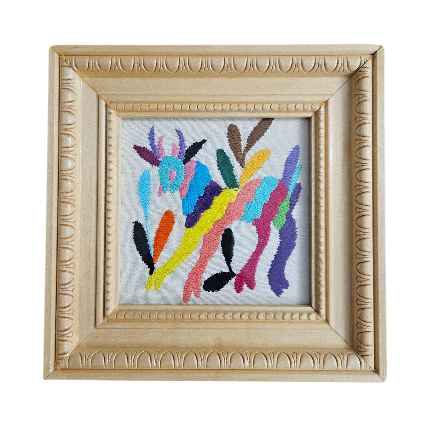 Framed colorful floral embroidery on a white background
